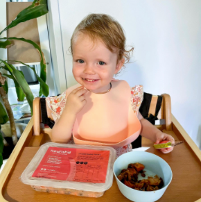Instagram image of a toddler in a high chair, enjoying a Nourish'd meal