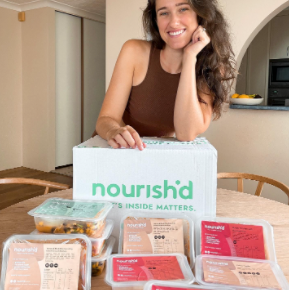 Instagram image of a fit man unpacking his Nourish'd box and loading his meals, drinks, and snacks onto his dining table.