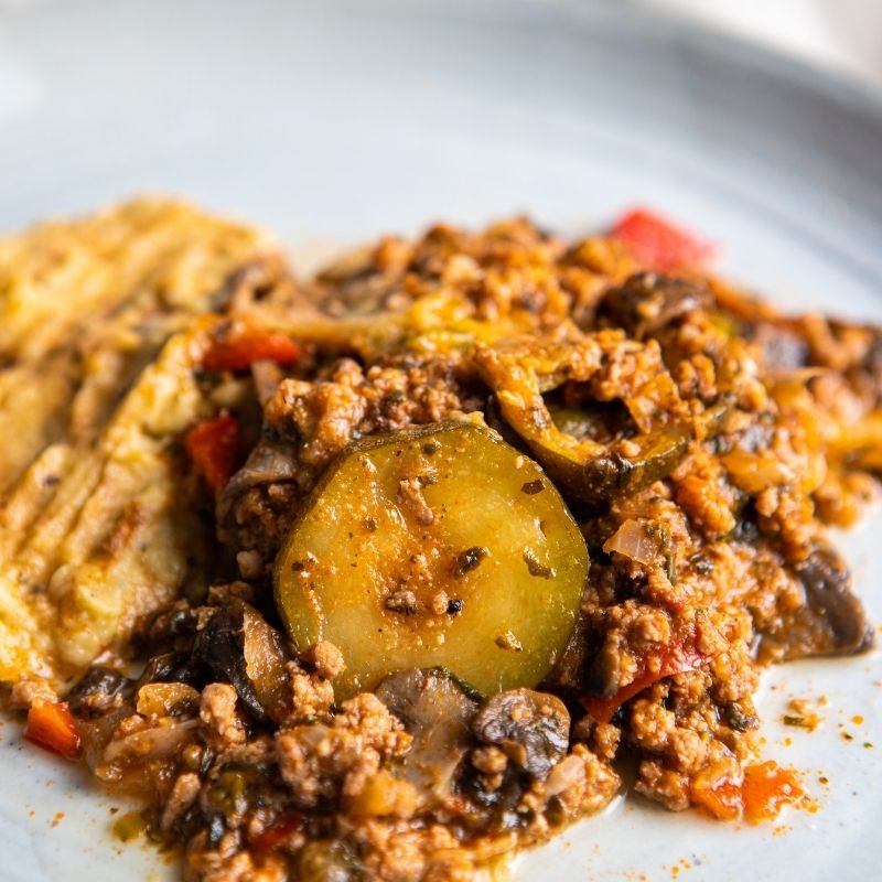 Close-up of the Savoury Mince with Baba Ganoush, highlighting the rich textures of the fried mince, sautéed vegetables, and smooth baba ganoush topping.